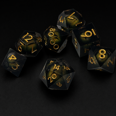 Set of black dice with gold numbers on a dark background